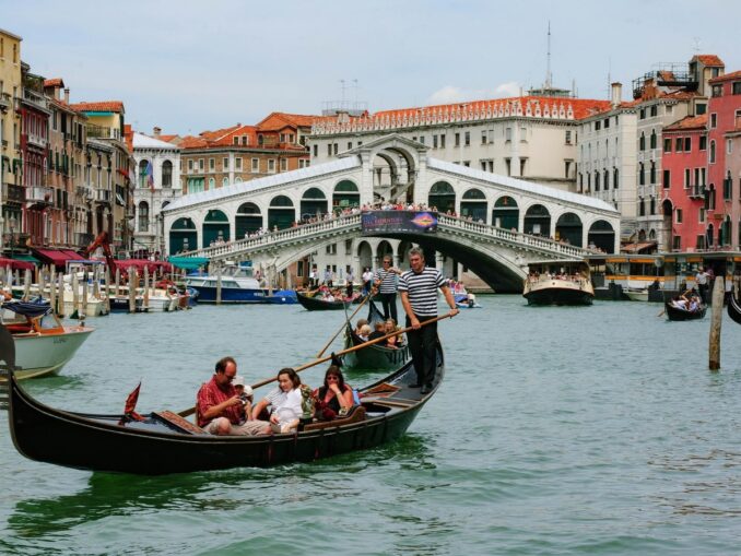 Gondolas on the background of the Rialto - it can be hot and cloudy in Venice in June